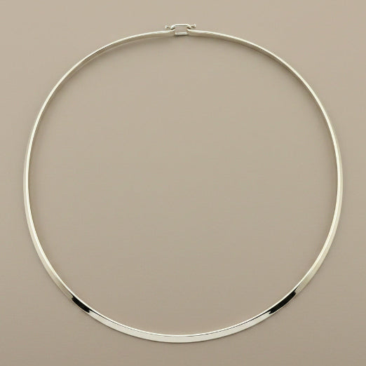 Silver necklace on a gray background