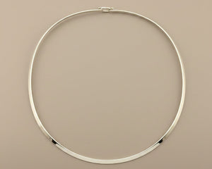 Silver necklace on a gray background