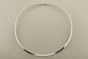 Silver necklace on a gray background