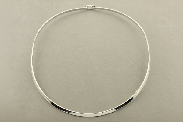 Silver necklace on a gray background