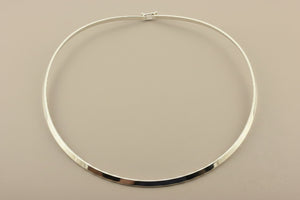 Silver necklace on a gray background