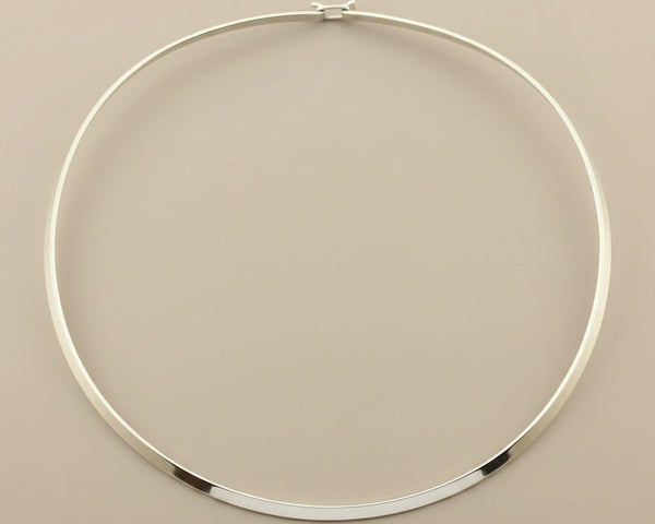 Silver necklace on a gray background