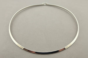 Silver necklace on a gray background