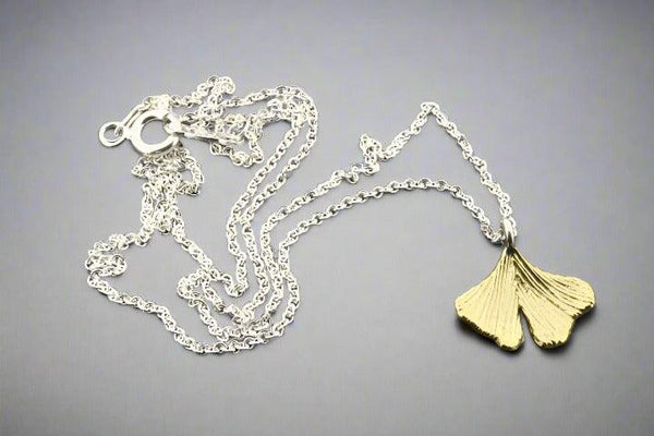 Brass ginkgo leaf pendant on silver necklace - Makers & Providers