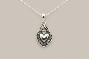 Silver pendant necklace on a gray background