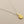 Load image into Gallery viewer, Gold shell pendant on a silver chain against a gray background
