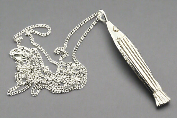 Silver chain with a decorative pendant on a dark gray background