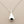 Load image into Gallery viewer, Silver teardrop pendant necklace on a gray background
