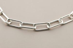 Silver chain necklace on a gray background
