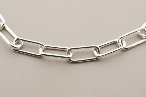 Silver chain necklace on a gray background