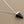 Load image into Gallery viewer, Black pyramid-shaped pendant on a silver chain against a gray background
