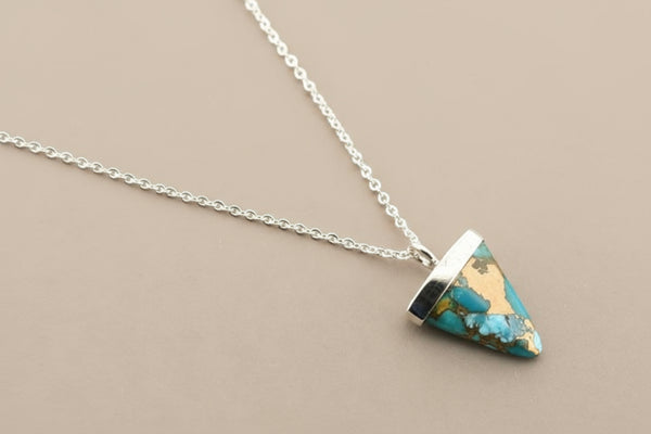 Necklace with a turquoise pendant on a gray background