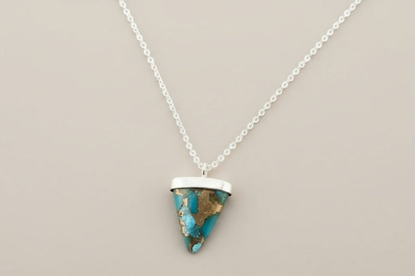 Necklace with a triangular pendant on a gray background