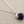 Load image into Gallery viewer, Necklace with a purple gemstone pendant on a gray background
