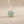 Load image into Gallery viewer, Necklace with a green pendant on a gray background

