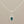 Load image into Gallery viewer, Silver pendant with a blue gemstone on a gray background
