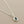 Load image into Gallery viewer, Silver necklace with a blue gemstone pendant on a gray background
