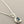 Load image into Gallery viewer, Silver necklace with a pendant featuring a blue gemstone on a gray background
