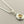 Load image into Gallery viewer, Silver necklace with a pendant featuring a yellow gemstone on a gray background

