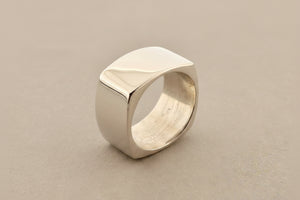 Silver ring on a dark gray background