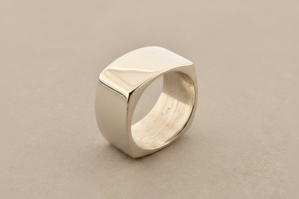 Silver ring on a dark gray background