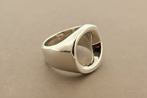 Silver ring on a gray surface