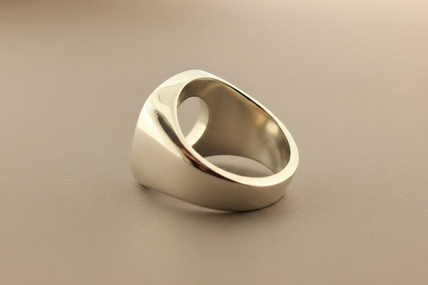 Silver ring on a gray surface