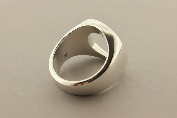 Silver ring on a gray surface