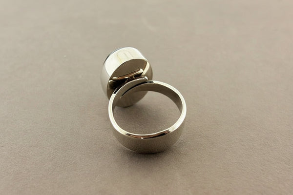Silver ring on a gray surface
