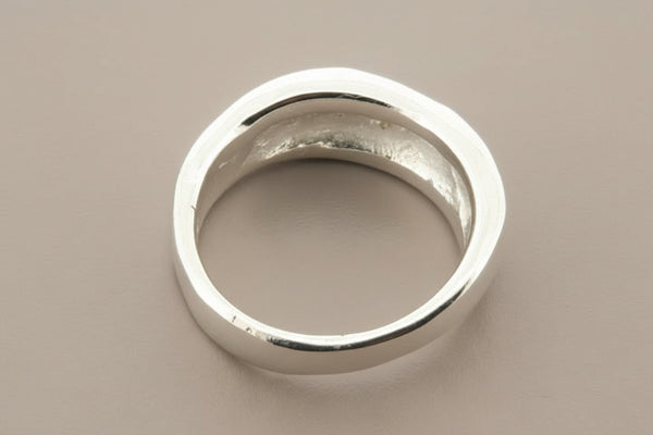Silver ring on a gray background
