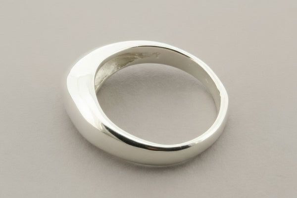 Silver ring on a gray background