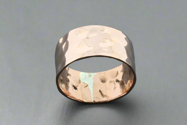 Hammered copper ring on a gray background