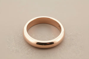 Rose gold ring on a gray background