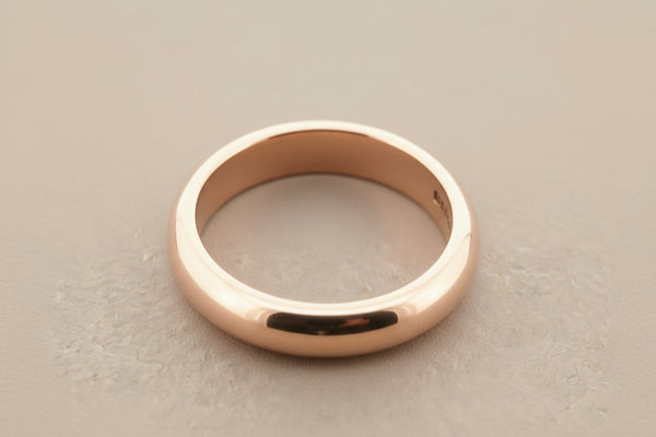 Rose gold ring on a gray background