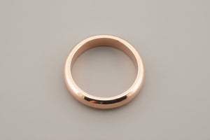 Rose gold ring on a gray background