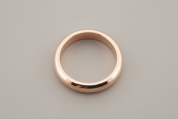 Rose gold ring on a gray background