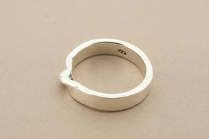 Silver ring on a gray background