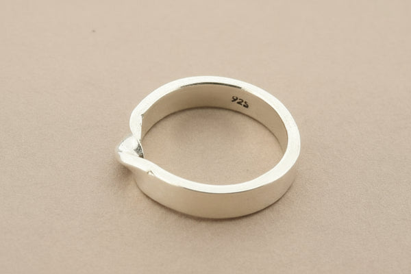 Silver ring on a gray background