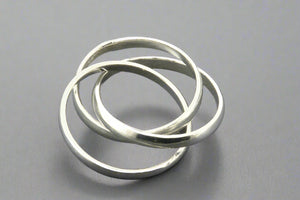 Three interlocking silver rings on a gray background