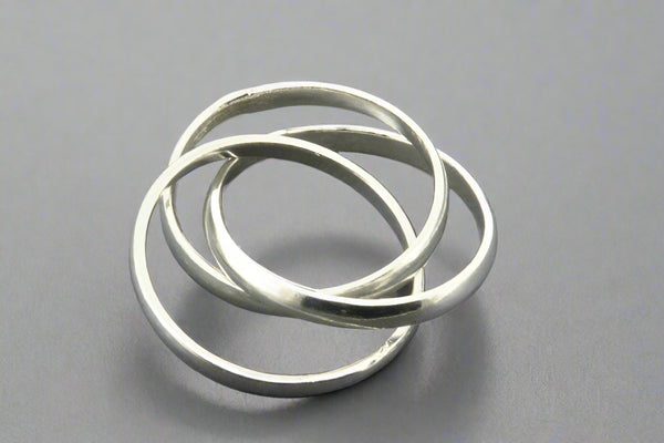 Three interlocking silver rings on a gray background