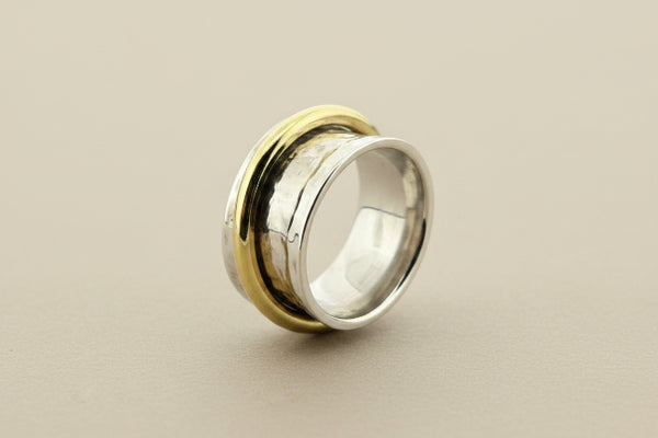 Concave hammered silver ring with brass spinner