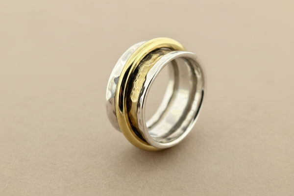 Concave hammered silver ring with brass spinner