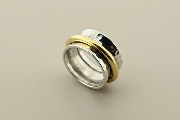 Concave hammered silver ring with brass spinner