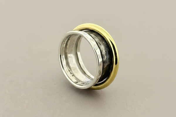 Concave hammered silver ring with brass spinner