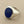 Load image into Gallery viewer, A silver signet ring featuring a round, deep blue lapis lazuli stone with visible golden flecks, set against a dark gray textured background.
