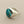 Load image into Gallery viewer, A silver signet ring featuring a round turquoise stone with brown matrix veining, displayed on a dark gray textured surface.
