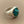 Load image into Gallery viewer, A silver signet ring featuring a round turquoise stone with brown matrix, photographed on a dark gray textured background.
