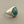 Load image into Gallery viewer, A sterling silver signet ring featuring a large oval turquoise stone with natural matrix lines, displayed on a dark gray textured surface.
