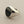Load image into Gallery viewer, A silver signet ring with a large, polished oval black onyx stone, photographed on a textured dark gray surface.
