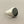 Load image into Gallery viewer, A silver signet ring with a polished oval black onyx stone, resting on a textured dark gray surface.

